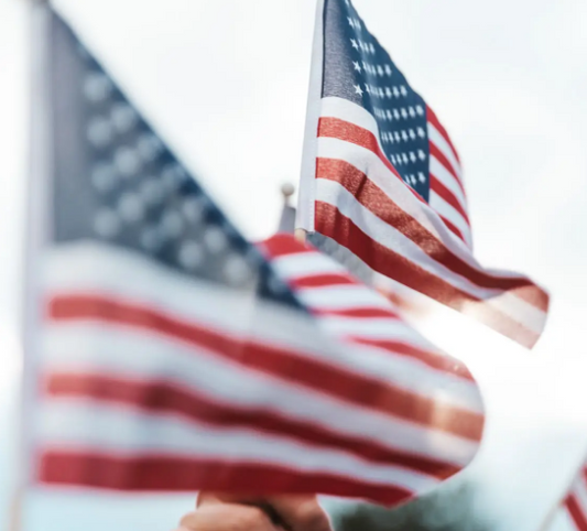 American flag displayed proudly, symbolizing patriotism and strength, alongside essential medical supplies like bandages, masks, and gloves.